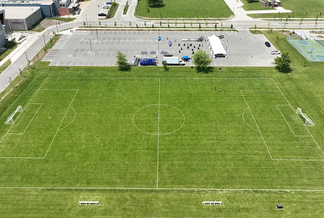 An aerial photo of the campus soccer field with parking lots in the view.