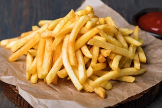 A photo of a plate of golden frensh fries.