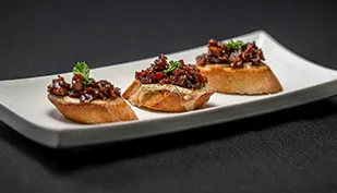 Brie and bacon on bread crostini.