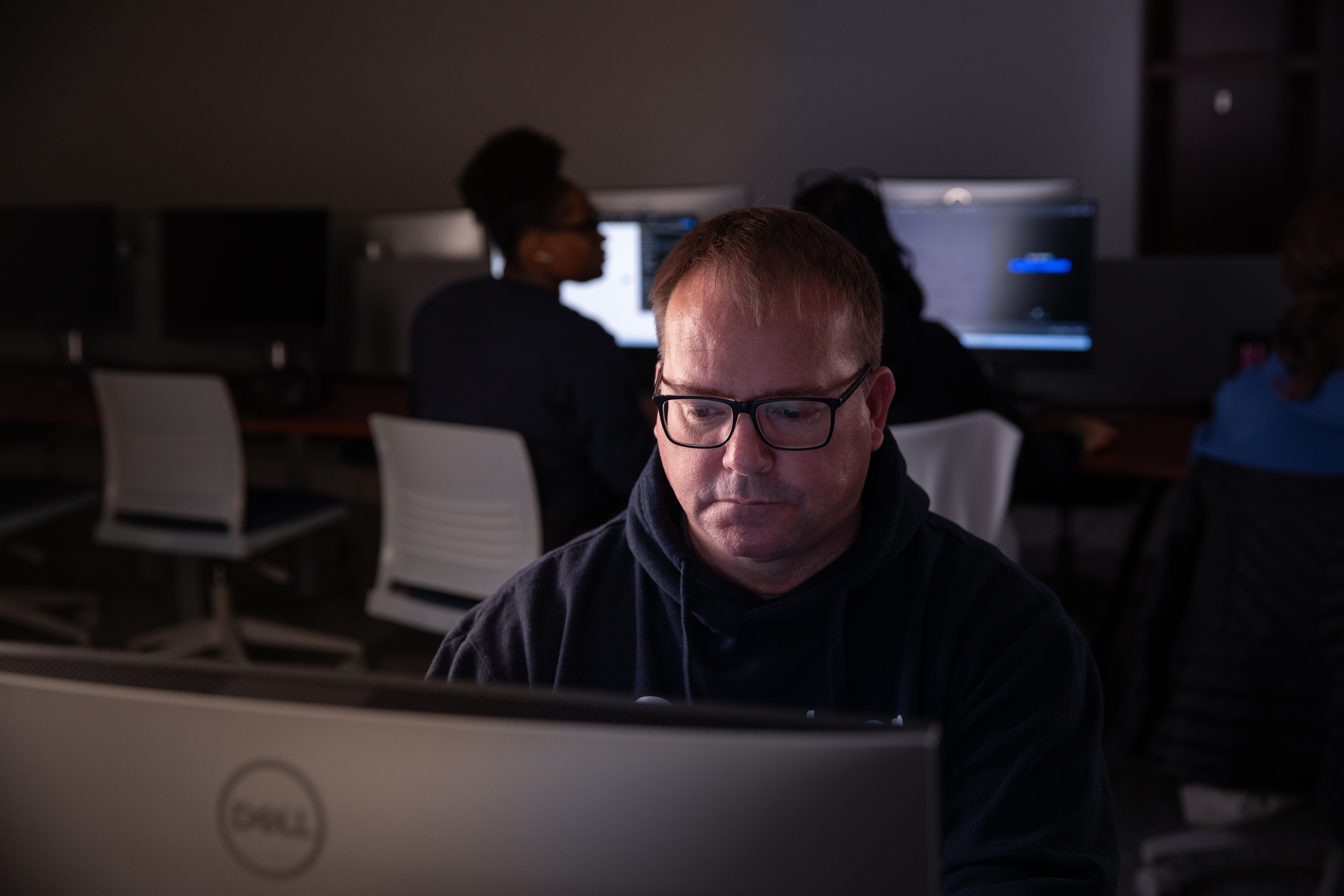 A white man using a computer
