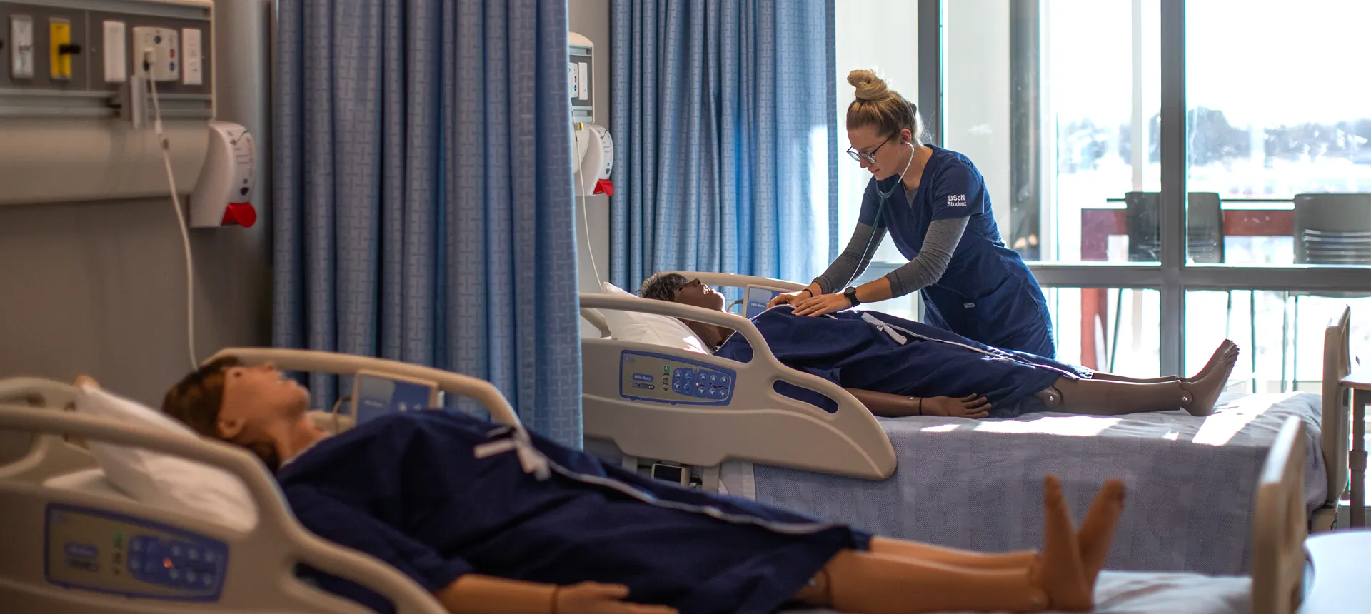 Nursing student checking vitals on mannequin