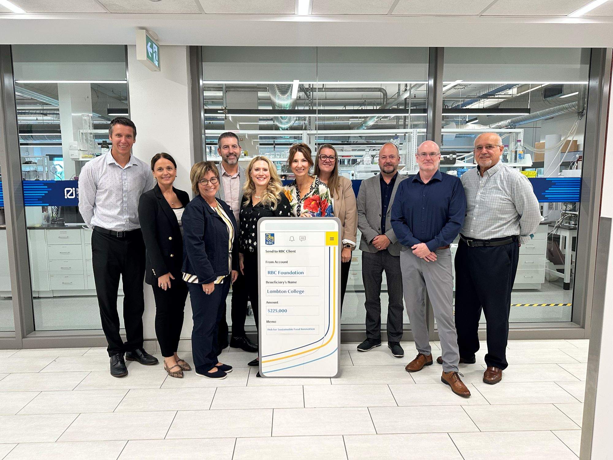 A group of people from Lambton's research department and RBC holding a funding cheque