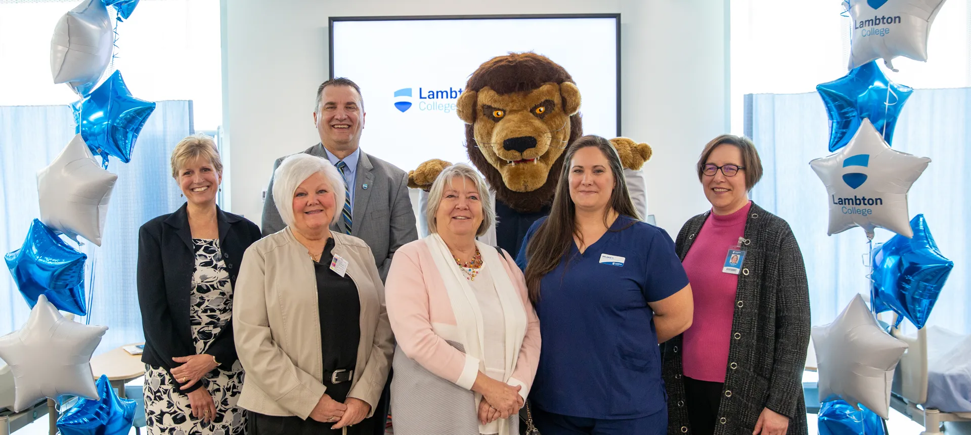 Lambton College Faculty, Staff, Students and mascot Pounce smile together