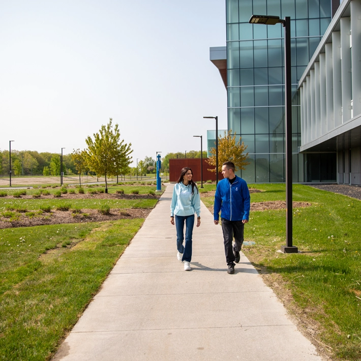 Two students walking outside on campus grounds