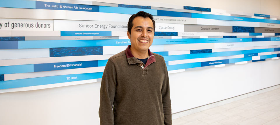 student-in-front-of-donor-wall Build a stronger Lambton County