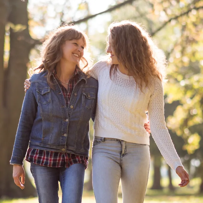 A mother walking with her daughter on a bright spring day.