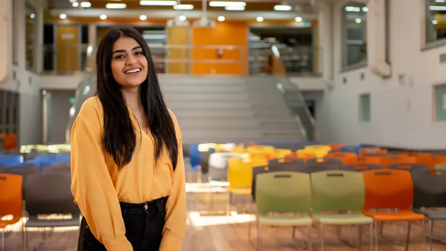 An international student posing for photo on campus.