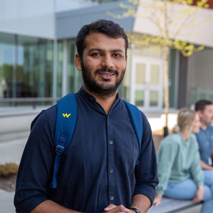 lifestyle-orientation-students-international Students posing for photo outside campus grounds wearing blue shirt and backback.