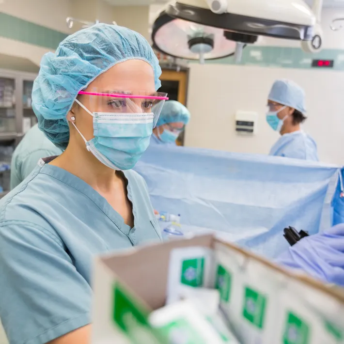 Nurse in operating room prepping for surgery.