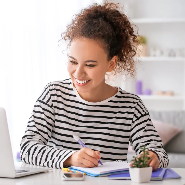 A female online learner sitting at desk.