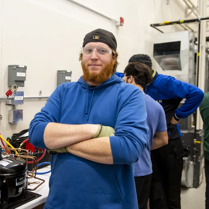 A student standing in HVAC lab.