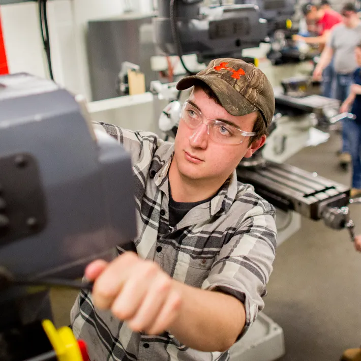 Millwright student using shop equipment.