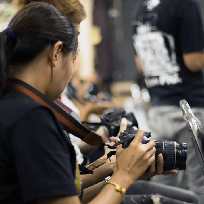 Photography students holding cameras.