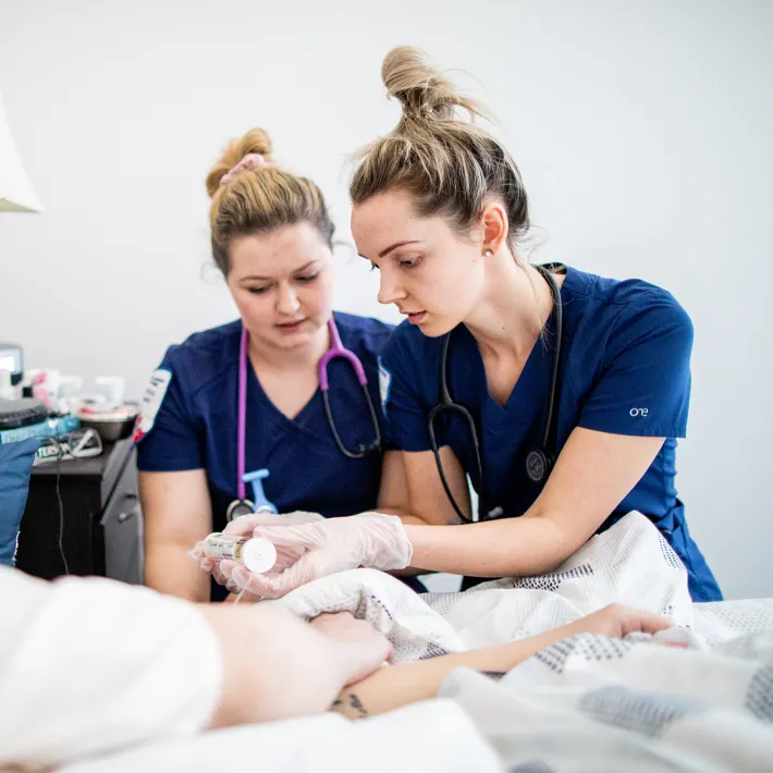 Two pswk students working with a patient.