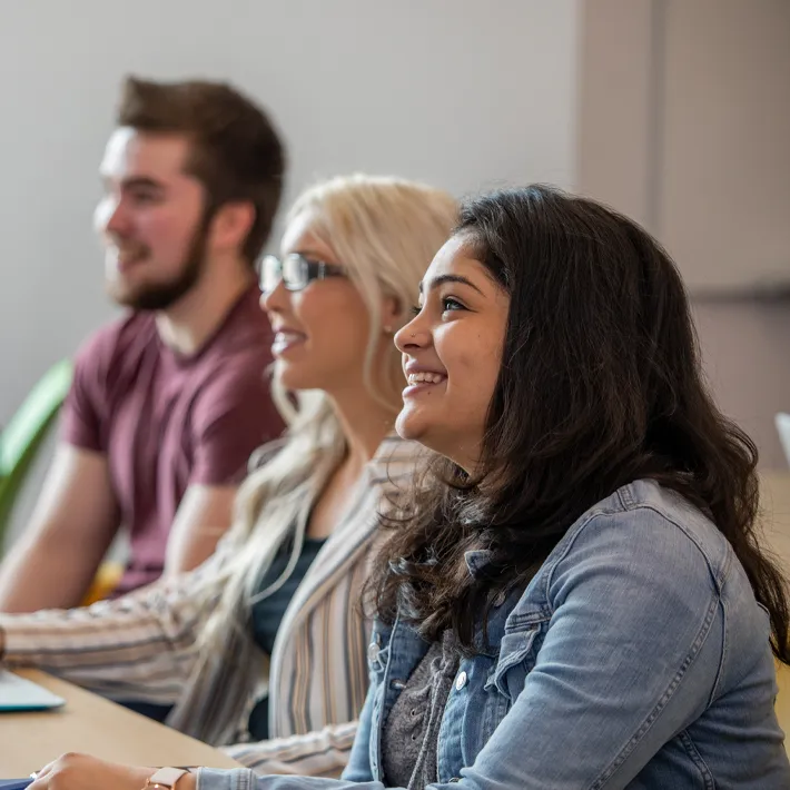 Students in classroom listening to lecture.