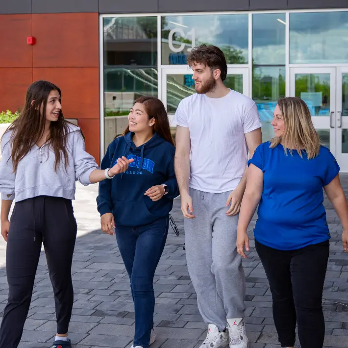 A group of students walking down a hall in Lambton College