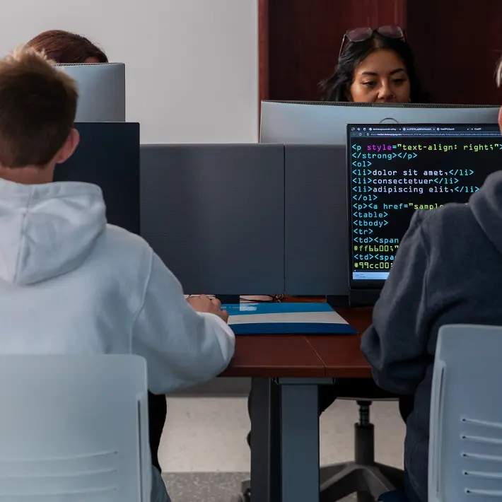 Student looking at his iPad in the hallway