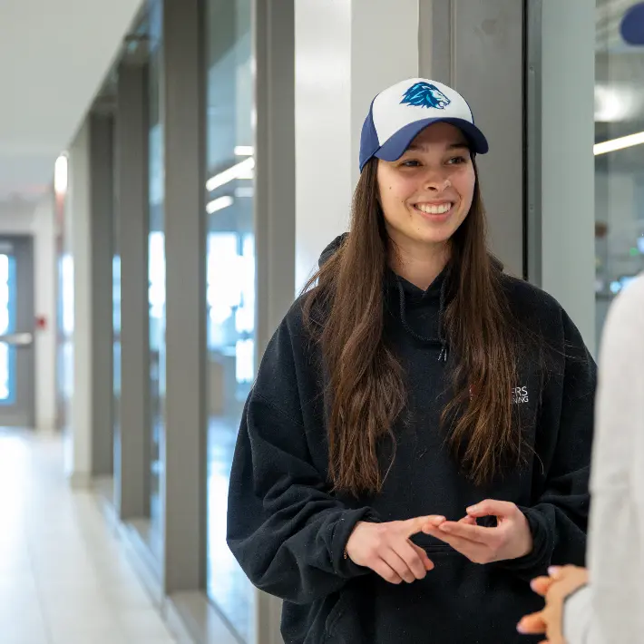 Students sitting outside of the main Lambton College building