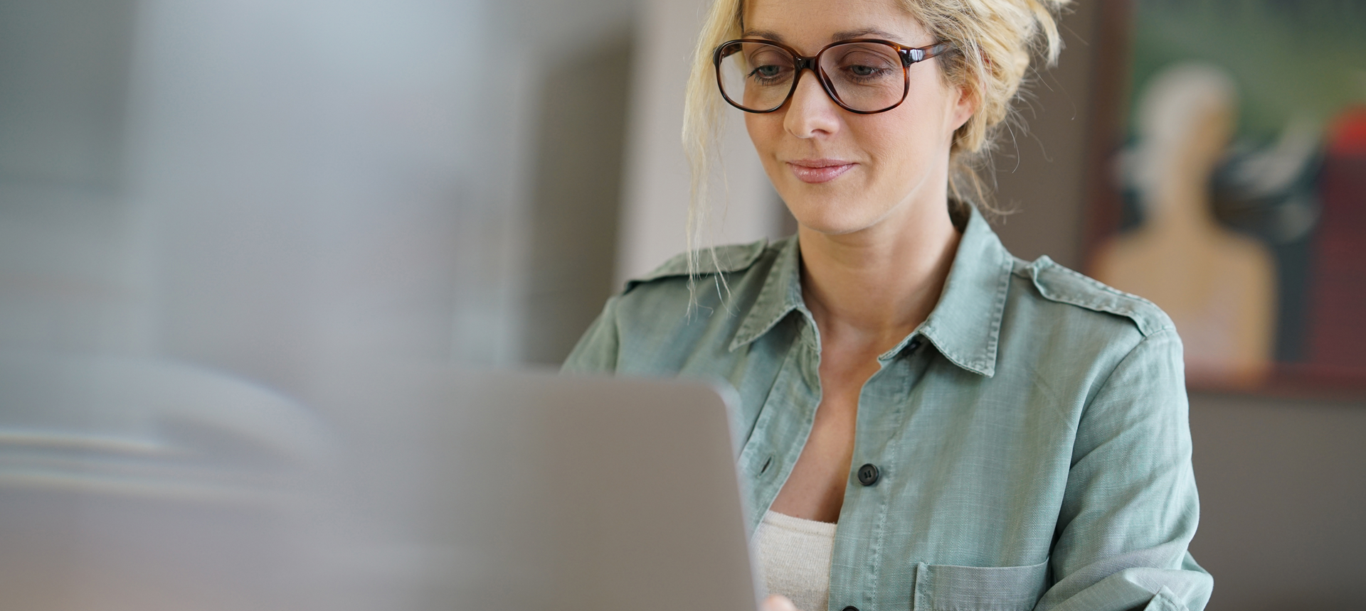A woman learning on a laptop
