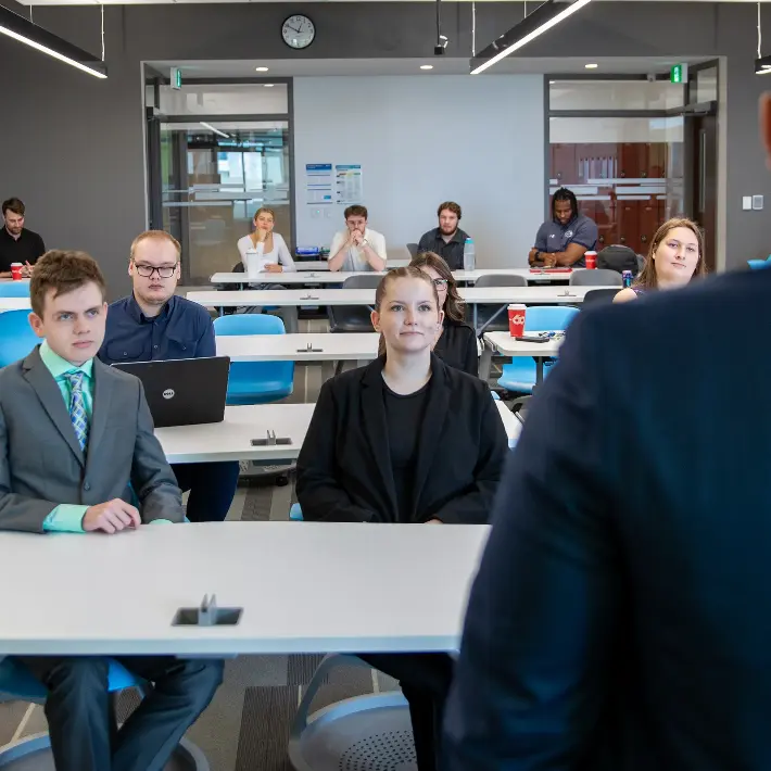 Business students on presentation day in classroom