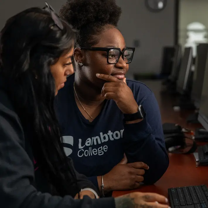 Two students working on a computer