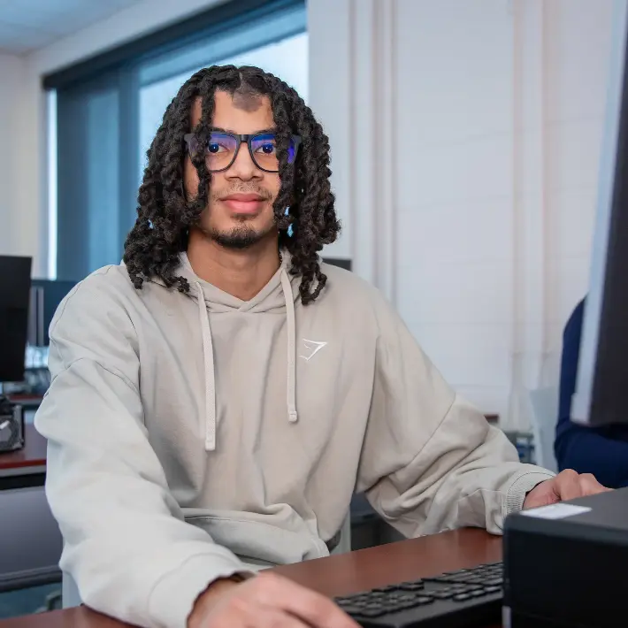 A student working on a computer in a lab