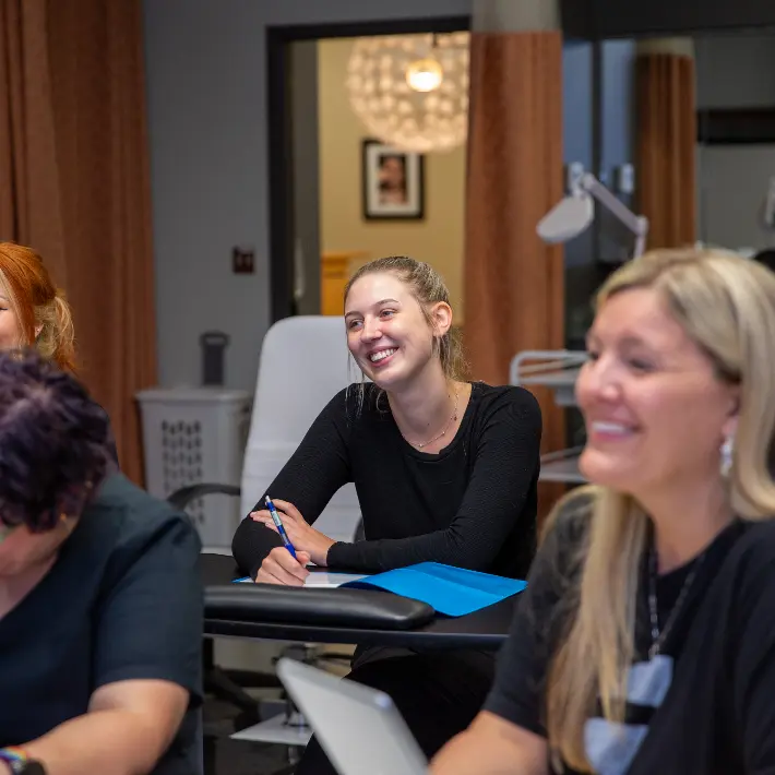ESTH Students in the lab sitting at desks writing notes.