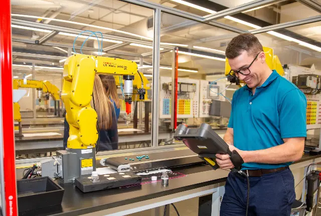 A student programming a robot