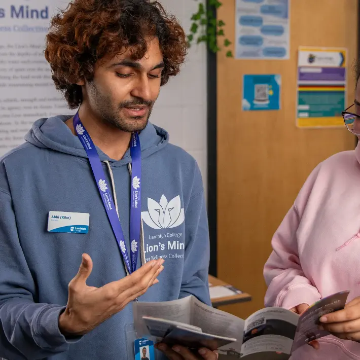 lions-mind-lions-pride Two students chatting about services offered at the Lion's Mind
