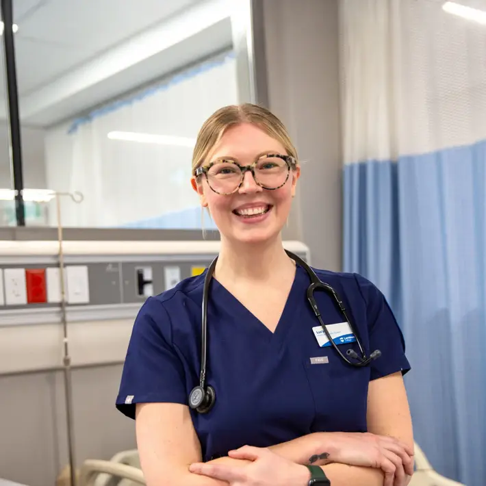 Nursing student smiling and folding her arms
