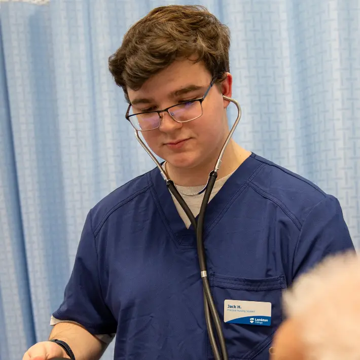 nursing-student Student is a nursing lab taking someone's vitals