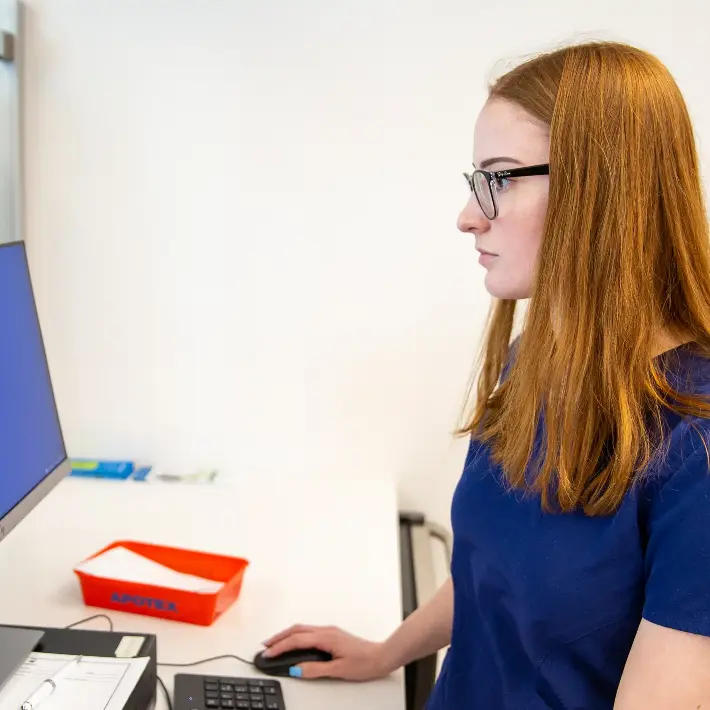 PHRM-PFND-RobberySimulation-2023-3-6_028 Medical student working on a computer in a health office