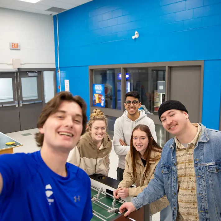 A student taking a selfie and hanging out in residence