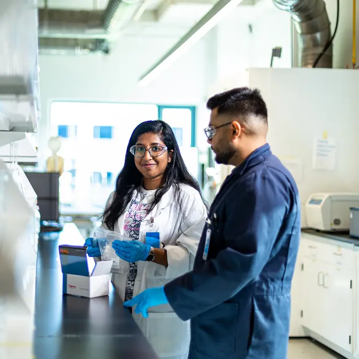 Students in research lab smiling