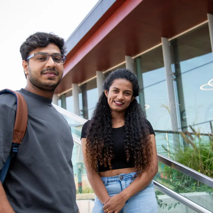 Two students outside of the building