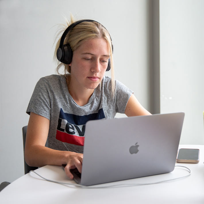 student-with-headphones-and-laptop Student wearing headphones and using laptop