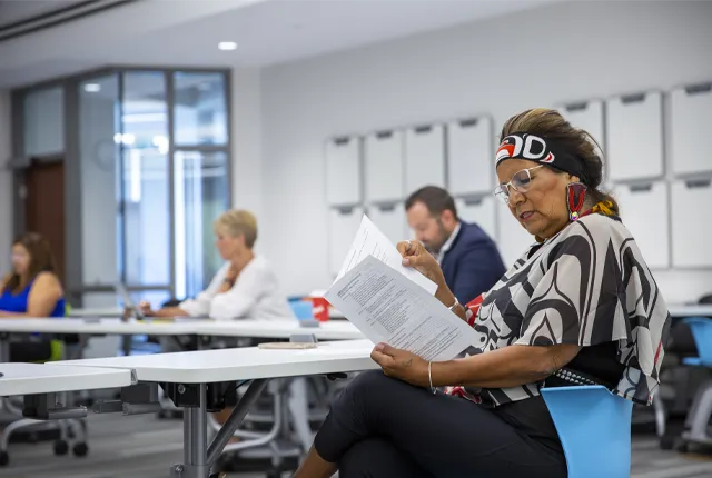 A photo of Phyllis George in an indigenous education council meeting.