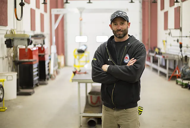A photo of a student posing in the steamfitter lab.