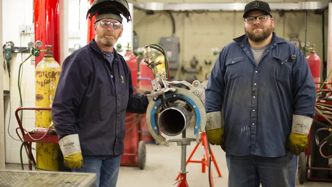 Students posing for photo in the steamfitter lab.